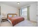 Bedroom with window and neutral colors at 1659 Duckworth Ave, Charlotte, NC 28208