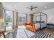 Bright bedroom with modern furnishings, a canopy bed, and large windows at 1659 Duckworth Ave, Charlotte, NC 28208