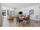 Open-concept dining room with contemporary lighting, hardwood floors, flowing into the living area at 1659 Duckworth Ave, Charlotte, NC 28208