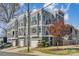 New townhome exterior featuring gray siding, multiple windows, balconies and attached garages at 1659 Duckworth Ave, Charlotte, NC 28208