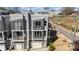 Aerial view of modern gray townhomes with balconies and attached garages in a residential area at 1659 Duckworth Ave, Charlotte, NC 28208