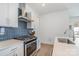 Kitchen featuring stainless steel appliances and modern backsplash at 1659 Duckworth Ave, Charlotte, NC 28208