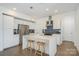 Bright, modern kitchen with white cabinets, stainless steel appliances, and a large island with seating at 1659 Duckworth Ave, Charlotte, NC 28208