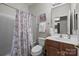 Bright bathroom with white shower featuring a floral curtain and a wood vanity at 1668 Onyx Rdg # 116, Fort Mill, SC 29708