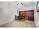 Bedroom featuring a built-in wood shelving unit with carpet and ceiling fan at 1668 Onyx Rdg # 116, Fort Mill, SC 29708