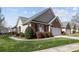 Beautiful brick home with a manicured lawn, vibrant flower bushes, and charming curb appeal at 1668 Onyx Rdg # 116, Fort Mill, SC 29708