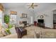 Bright living room featuring a fireplace, ceiling fan, hardwood floors, with windows and natural light at 1668 Onyx Rdg # 116, Fort Mill, SC 29708