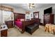 Luxurious main bedroom with dark wood furniture set, a ceiling fan, and plush carpeting at 1668 Onyx Rdg # 116, Fort Mill, SC 29708