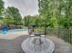 Inviting backyard deck with a round rug, stylish seating, and a view of the swimming pool at 18 Pickett Ave, Spencer, NC 28159