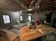 Unfinished basement with exposed ceiling and block walls, offering potential for customization at 18 Pickett Ave, Spencer, NC 28159