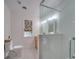Bright bathroom featuring white tile walls, modern glass shower, and stylish window treatment at 18 Pickett Ave, Spencer, NC 28159