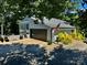 Stunning home featuring an attached garage, complemented by an American flag and meticulously landscaped grounds at 18 Pickett Ave, Spencer, NC 28159