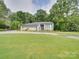 Well-manicured front lawn and large modern house with unique window arrangement and front door at 18 Pickett Ave, Spencer, NC 28159