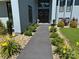 Charming home entrance with a well-maintained walkway, decorative wreaths, and colorful landscaping at 18 Pickett Ave, Spencer, NC 28159