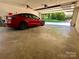Garage featuring a red Tesla with the garage door open to the exterior landscape at 18 Pickett Ave, Spencer, NC 28159