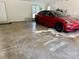 Spacious garage with a red Tesla car, ample space for storage and a laundry room at 18 Pickett Ave, Spencer, NC 28159