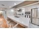 Modern kitchen featuring an island with seating, stainless steel appliances, and ample cabinet space at 18 Pickett Ave, Spencer, NC 28159