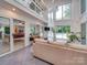 Living room with high ceilings, large windows, and open access to other rooms at 18 Pickett Ave, Spencer, NC 28159