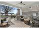 This is a back porch overlooking the water with a ceiling fan and table and chairs at 20601 Island Forest Dr, Cornelius, NC 28031