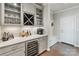 Chic bar area with built-in wine fridge and glass display cabinets at 20601 Island Forest Dr, Cornelius, NC 28031