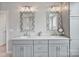 Stylish bathroom featuring dual sinks and modern vanity with decorative mirrors at 20601 Island Forest Dr, Cornelius, NC 28031