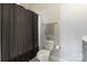 Cozy bathroom featuring a toilet and a dark shower curtain at 20601 Island Forest Dr, Cornelius, NC 28031