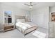 Bright bedroom featuring a large bed, white bedding, and natural light streaming through the windows at 20601 Island Forest Dr, Cornelius, NC 28031