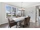 Elegant dining room featuring a modern chandelier and scenic backyard views at 20601 Island Forest Dr, Cornelius, NC 28031