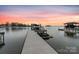 Private boat dock and slip at sunset on a calm lake at 20601 Island Forest Dr, Cornelius, NC 28031