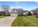Charming two-story home with landscaped front yard, dormer windows, and a three car garage at 20601 Island Forest Dr, Cornelius, NC 28031