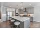 Open kitchen featuring a central island with seating and modern stainless steel appliances at 20601 Island Forest Dr, Cornelius, NC 28031