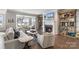 Cozy living room with fireplace, built-in shelving, hardwood floors, and view to sunroom at 20601 Island Forest Dr, Cornelius, NC 28031