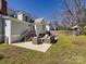 Backyard featuring a patio area with outdoor seating, stairs to the back door, and grassy lawn at 225 Marion St, Rock Hill, SC 29730