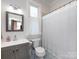 Bright bathroom with a shower/tub combo, window, patterned floor, and vanity at 225 Marion St, Rock Hill, SC 29730