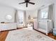 Bright Bedroom featuring hardwood floors, large windows, a crib, and a dresser at 225 Marion St, Rock Hill, SC 29730