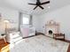 Bright Bedroom with hardwood floors, two windows, a fireplace, and a crib at 225 Marion St, Rock Hill, SC 29730