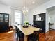 Cozy dining room with wood floors, black accents, and a charming fireplace at 225 Marion St, Rock Hill, SC 29730