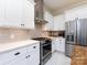 Contemporary kitchen featuring white cabinets, stainless steel appliances, and a subway tile backsplash at 225 Marion St, Rock Hill, SC 29730