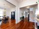 Open-concept living area with hardwood floors, a fireplace, and staircase at 225 Marion St, Rock Hill, SC 29730