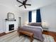 Main bedroom featuring a fireplace, ceiling fan, hardwood floors and bright windows at 225 Marion St, Rock Hill, SC 29730