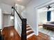 Staircase with white railing leading to the second floor with view into main bedroom at 225 Marion St, Rock Hill, SC 29730