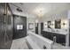 A luxurious bathroom with a glass-enclosed shower, chandelier, and double vanity sinks with modern fixtures at 2325 Winthrop Ave, Charlotte, NC 28203