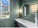 Stylish powder room featuring a modern vanity, elegant mirror, and chic lighting fixtures, creating a sophisticated space at 2325 Winthrop Ave, Charlotte, NC 28203