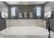 Modern bathroom featuring a standalone tub and a dual shower behind a glass divider with luxurious finishes at 2325 Winthrop Ave, Charlotte, NC 28203