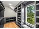 Walk-in closet with custom shelving, hardwood floors, and natural light from the window at 2325 Winthrop Ave, Charlotte, NC 28203