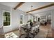 Bright dining room with beamed ceiling, modern lighting, and seamless access to the open kitchen at 2325 Winthrop Ave, Charlotte, NC 28203