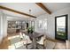 Bright dining room featuring wood beams, modern lighting, and a view into the open concept kitchen at 2325 Winthrop Ave, Charlotte, NC 28203