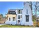 Beautifully designed exterior of a modern white brick home with unique architectural details and dark window trim at 2325 Winthrop Ave, Charlotte, NC 28203