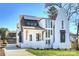 Stunning exterior of a brick home featuring modern design elements and manicured landscaping under a clear blue sky at 2325 Winthrop Ave, Charlotte, NC 28203