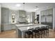Bright kitchen showcases a spacious island with bar seating, custom cabinets, and stainless steel appliances at 2325 Winthrop Ave, Charlotte, NC 28203